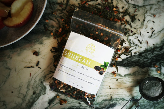 Sunbeam herbal tea blend with lemon verbena, lemongrass, ginger root, and hibiscus in premium packaging.