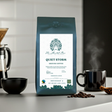 Coffee bag labeled 'Quiet Storm' with a coffee cup and beans on a kitchen counter.